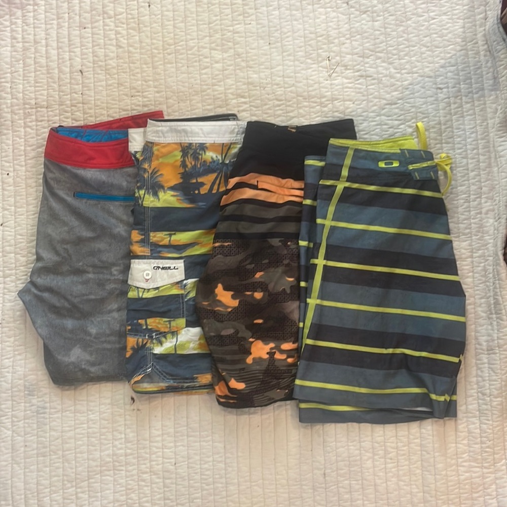 4 men’s swim trunks,-Oakley and O’Neill. Size 34 waist.